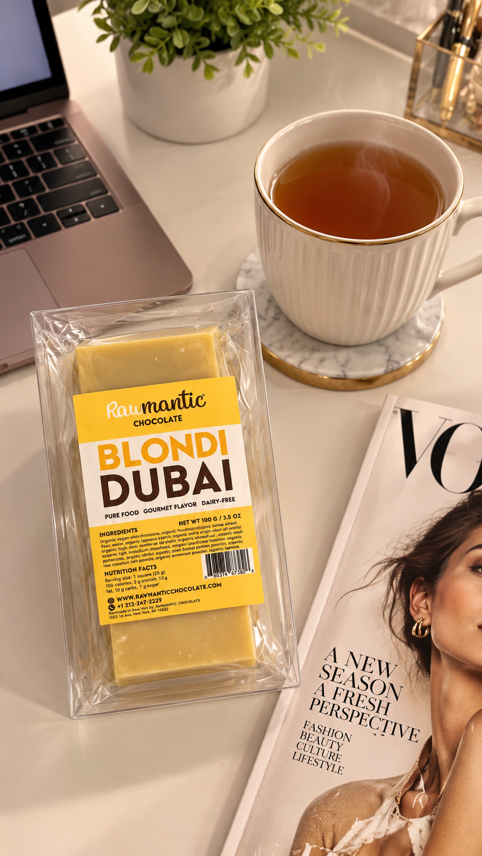 Blondi Dubai white chocolate bar on a desk with a cup of tea