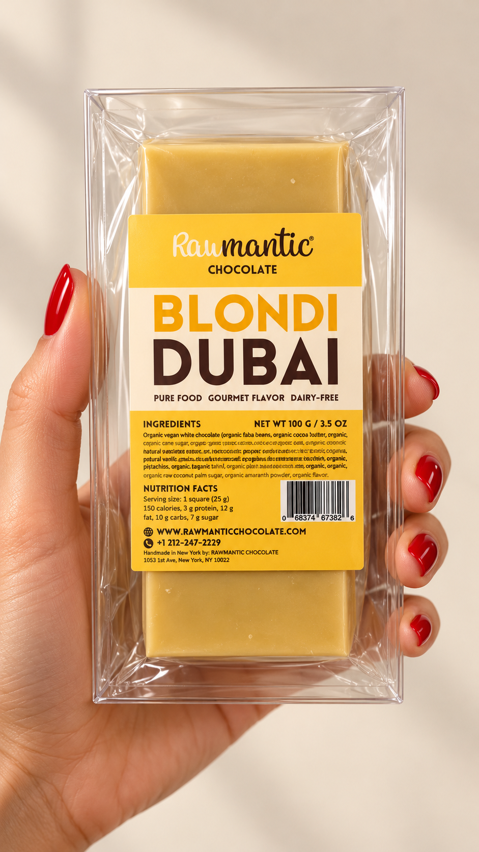 Hand holding a Blondi Dubai vegan white chocolate bar in its package