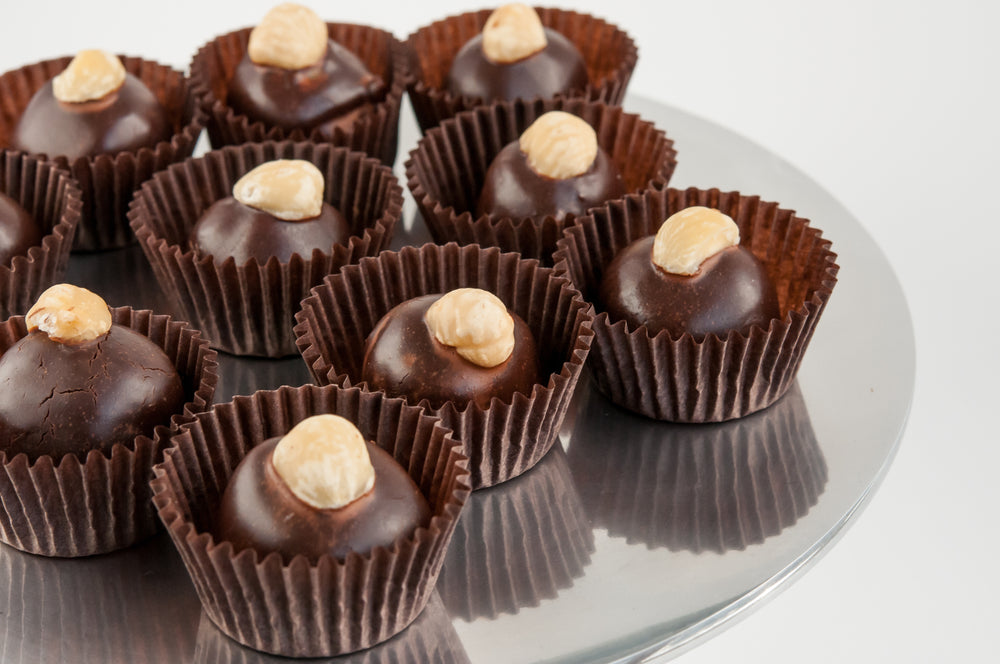 Close-up of Hazelnut Bliss vegan truffles on a silver serving tray