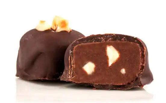 Dark Selection vegan chocolate truffle cut open showing nut pieces inside