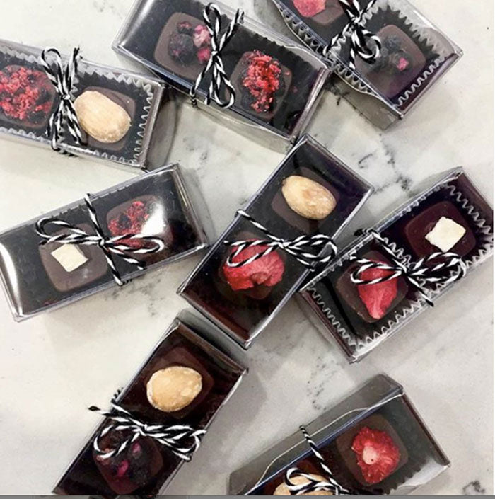 Individually wrapped 2-piece raw chocolate truffle sets with ribbon
